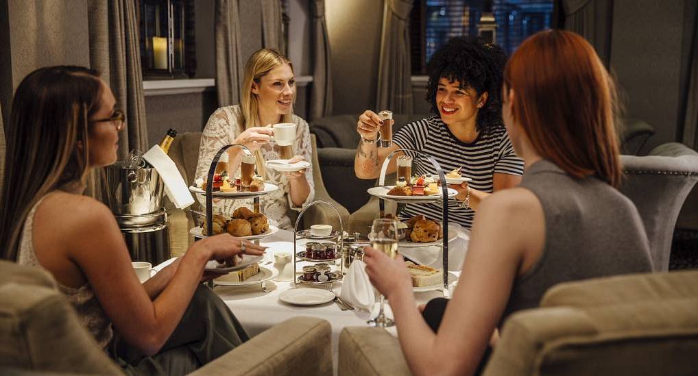 Woman enjoying afternoon tea and bubbles