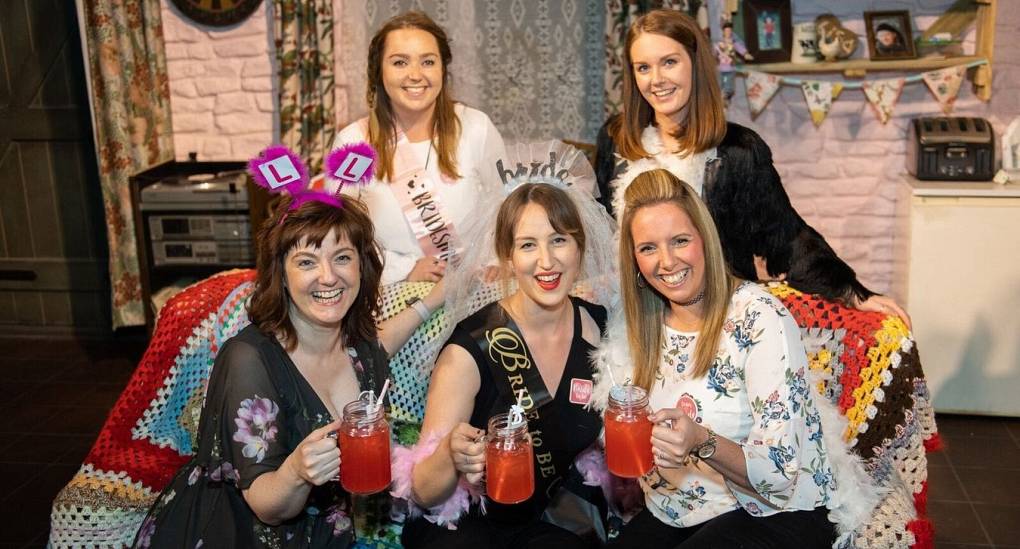 Hen party sitting on the famous Dingle couch in the Emmerdale Studio Experience