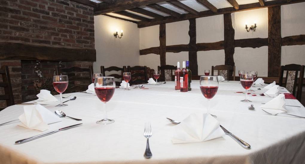 Large dining room table set up for a murder mystery evening