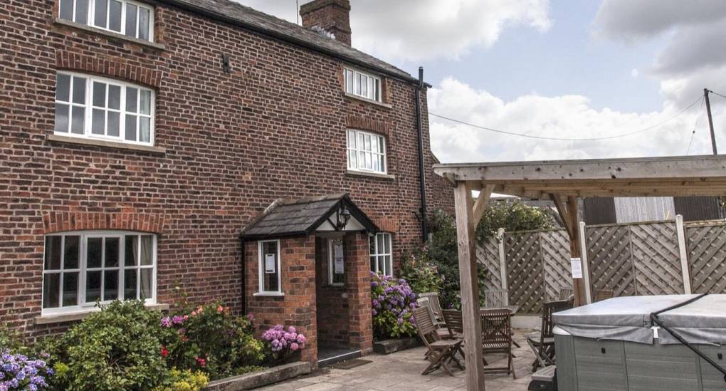 Front of the house with hot tub in view