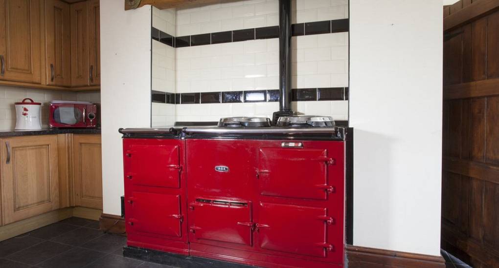 Farmhouse kitchen with large red aga