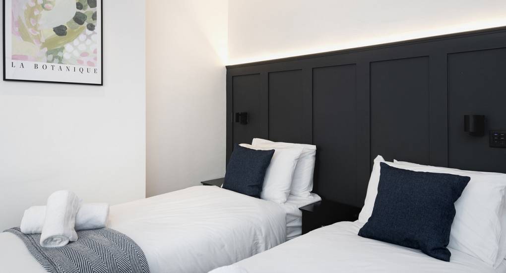 Flexible twin beds or king-size configuration in a Skyline Hen Party Bedroom