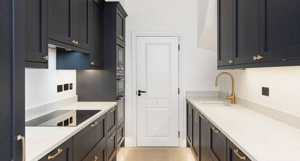 Compact, well-equipped galley kitchen at Skyline Bath luxury accommodation